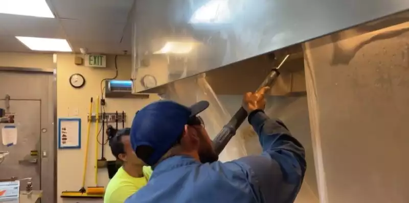 Cleaning Kitchen Exhaust in Naples Restaurant by Crowther Roofing and Cooling