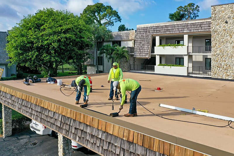 Crowther Roofing and Cooling is Torching the roof as part of a new roof installation on condos in Naples, FL. These services are available in Fort Myers and Sarasota